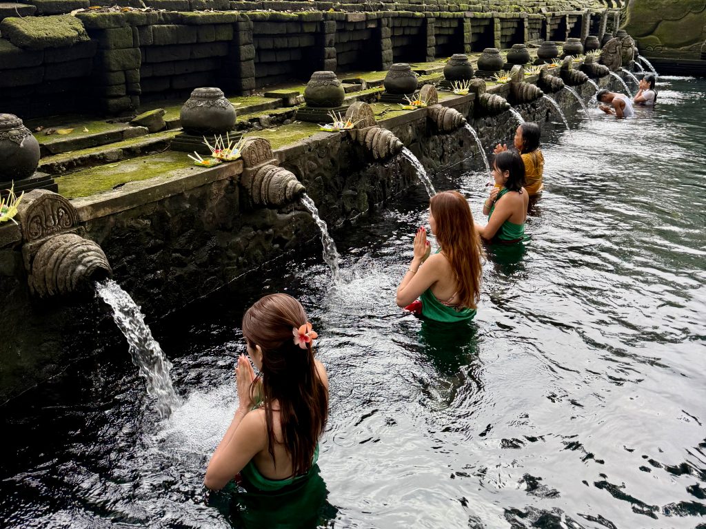 Tirta Empul Temple purification ritual, visitors bathing in holy spring | THE DAILY HAPPINESS