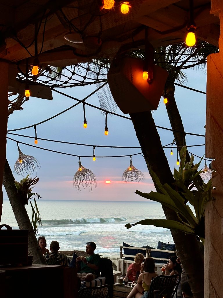 La Brisa Bali beach club, sunset over palm-fringed pool in Canggu | THE DAILY HAPPINESS