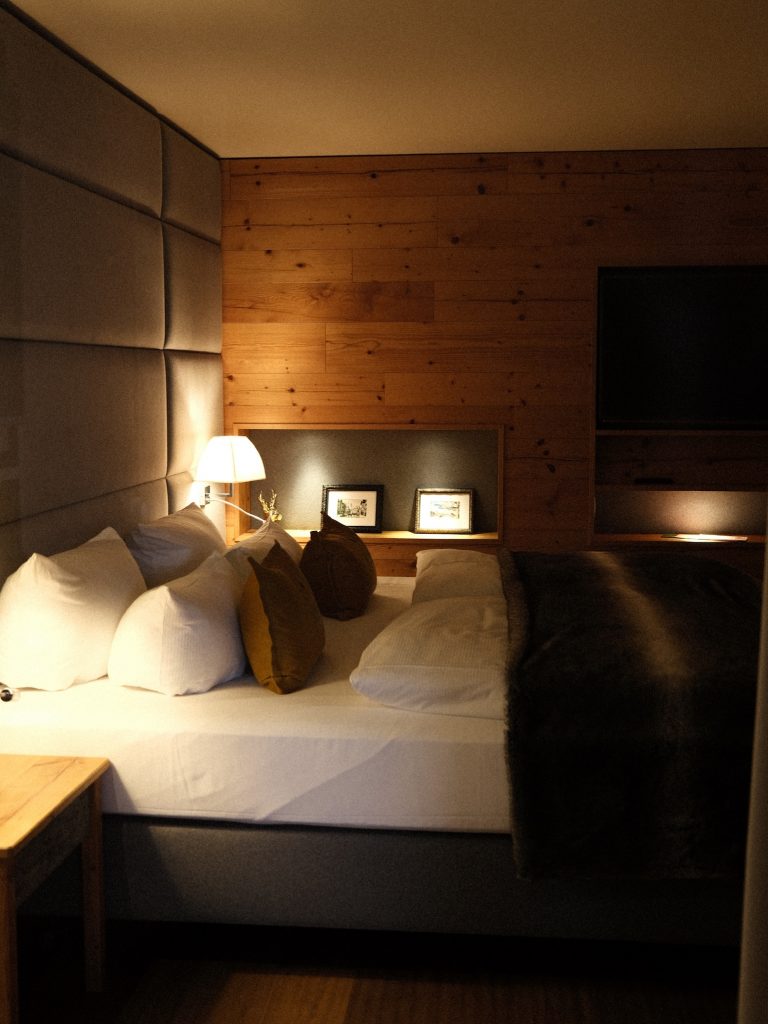 Cozy winter hotel room with soft lighting and warm textures, creating a comforting space for winter self-care and relaxation. | THE DAILY HAPPINESS