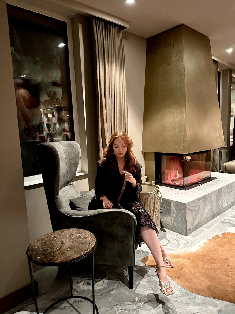 Elegant winter evening by a glowing fireplace, enjoying a peaceful and luxurious self-care moment. | THE DAILY HAPPINESS