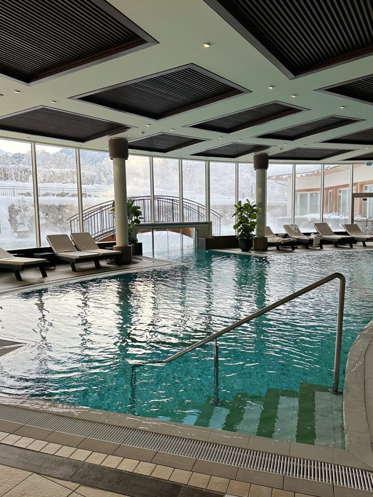Relaxing at an indoor spa with snowy views, a soothing winter self-care ritual for rest and relaxation. | THE DAILY HAPPINESS