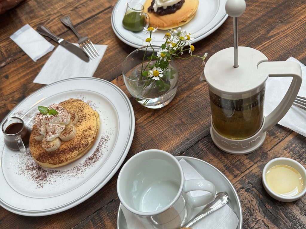 Cozy winter brunch with pancakes and tea, a comforting moment that fits gentle winter self-care rituals. | THE DAILY HAPPINESS