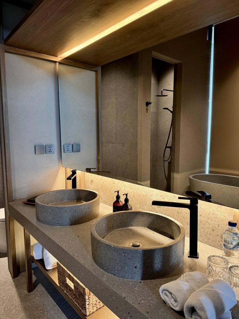 Calm hotel bathroom designed for slow mornings and intentional self-care rituals.