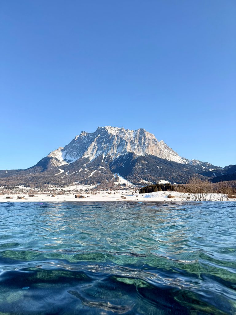 Winter mountain landscape with clear water, symbolising slowing down and starting with intention.